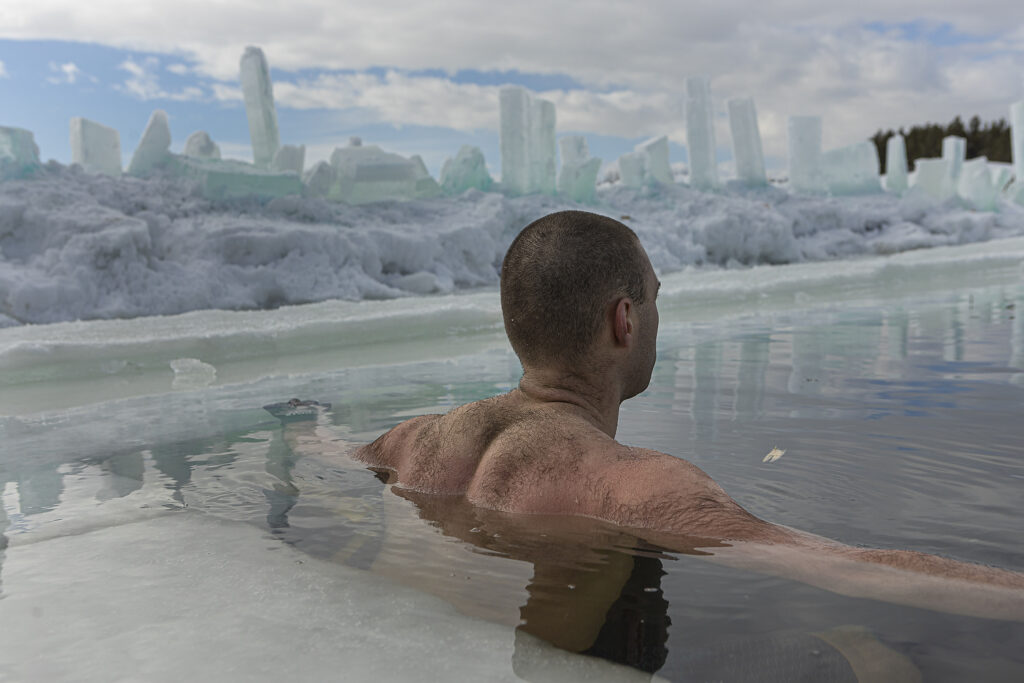 Martin Brunet relaxes in the icy water of a lake.