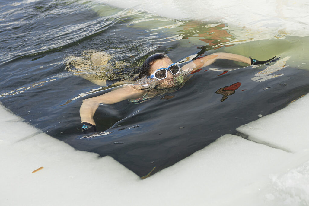 Manon Levesque swims into the cold water of a frozen lake